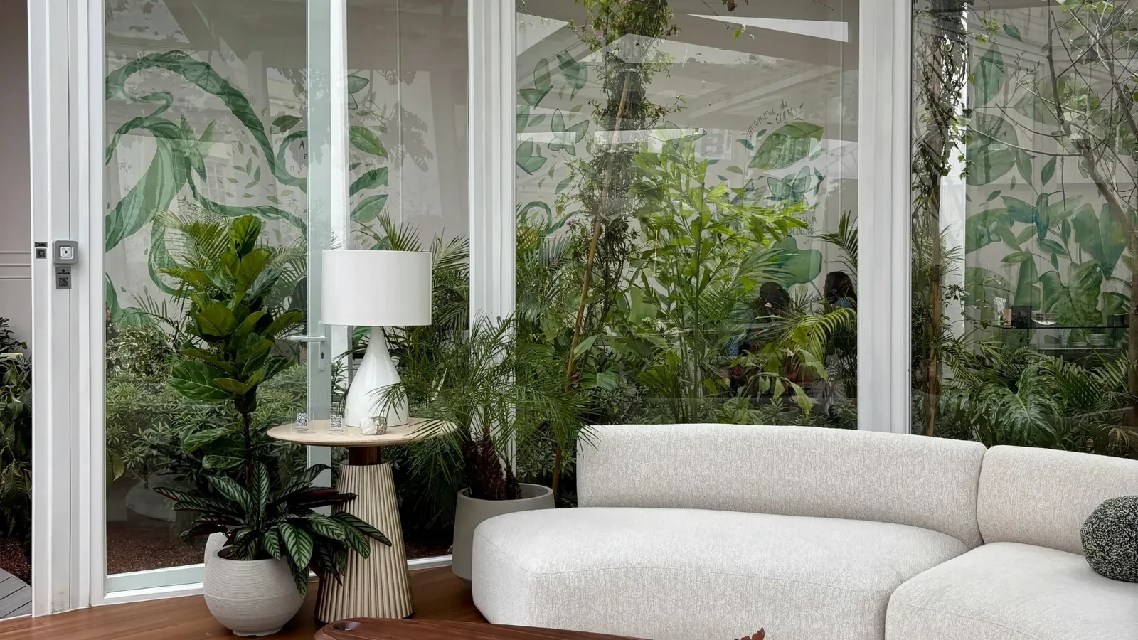 Glazed conservatory with a sofa and indoor plants